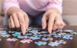 A senior woman doing a puzzle to help maintain and improve cognitive functions