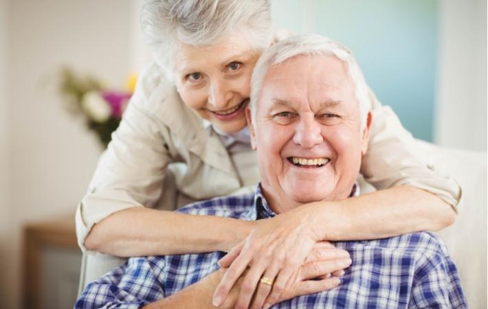 Two seniors smiling with joy in their independent living community