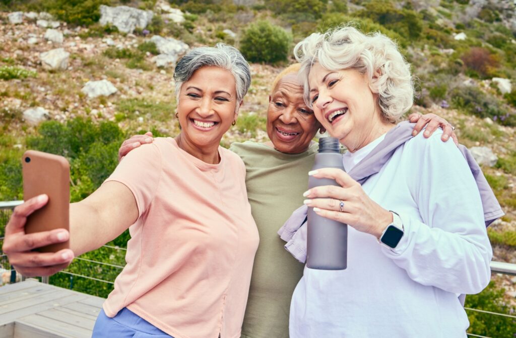 A group of friends pose to take a photo for an Instagram post.