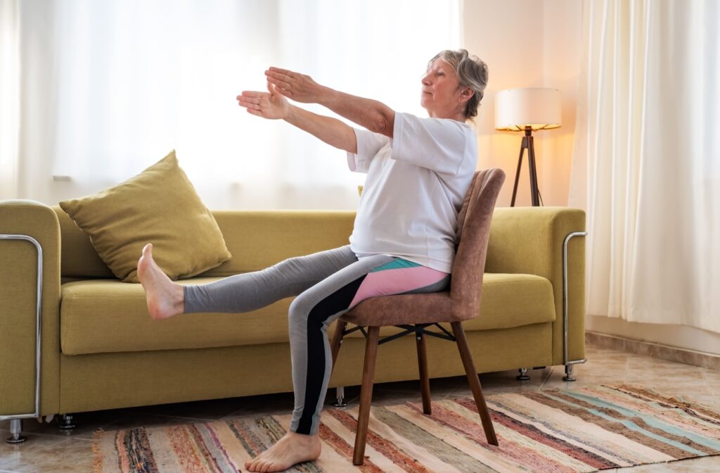 a senior participating in chair yoga to support limited mobility needs.