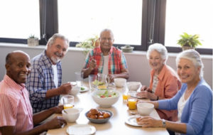 A group of seniors having breakfast together in an independent living community